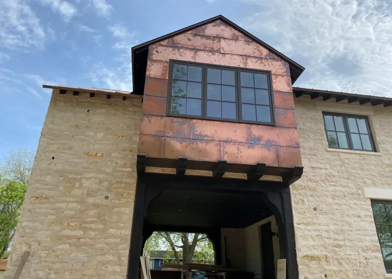 Copper metal panel facade on a stone building for Metal Roof Coating in Breaux Bridge